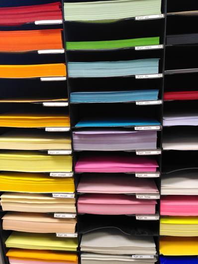 colourful stationery which is vertically stored and arranged by colour
